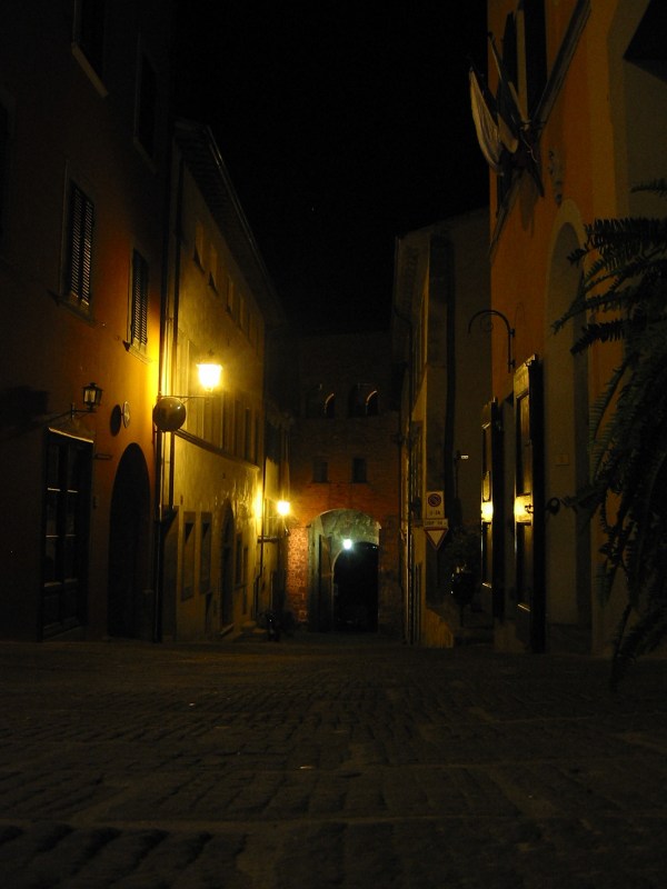 View of gate from within city wall at night